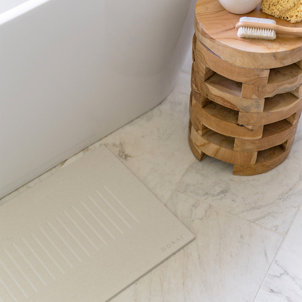 stone bath mat on bathroom floor