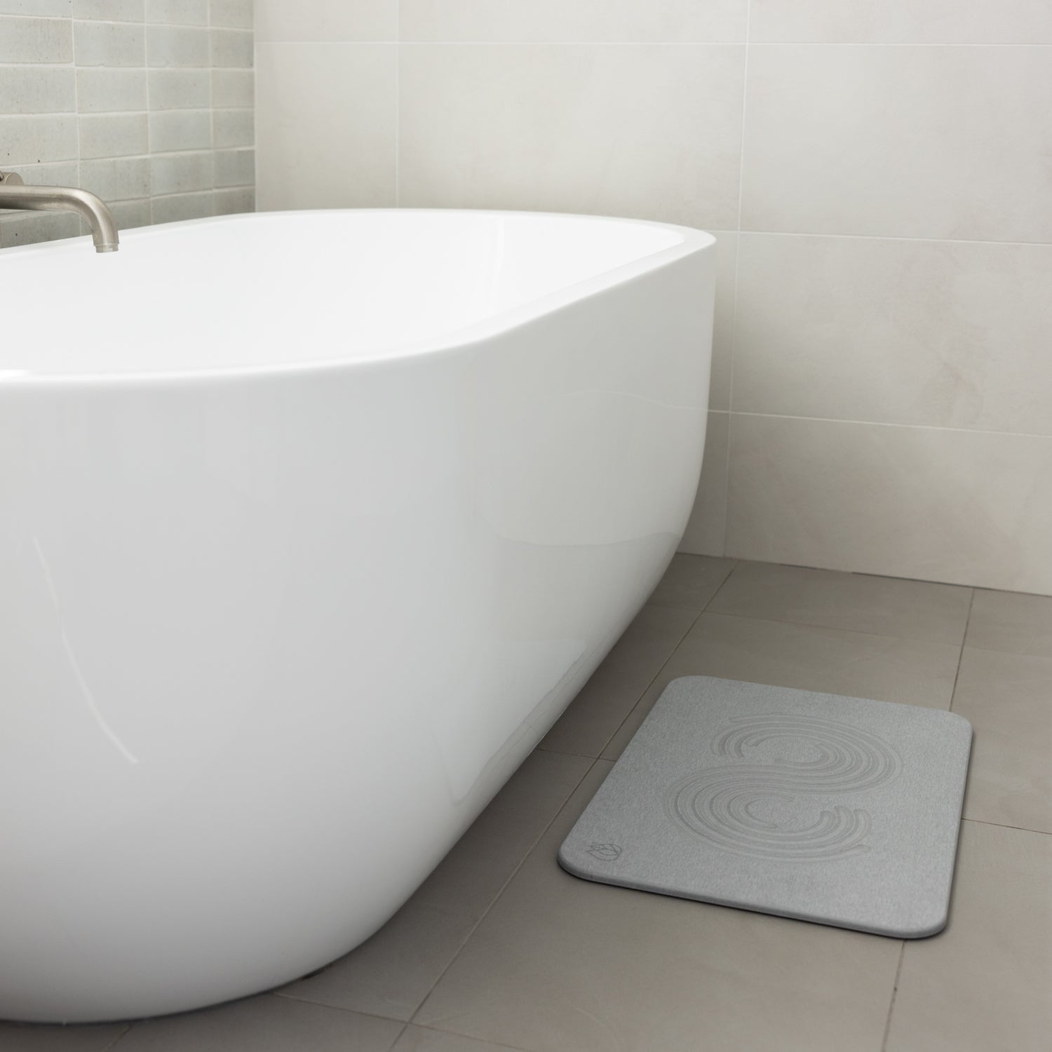 stone shower bath mat in front of bath tub