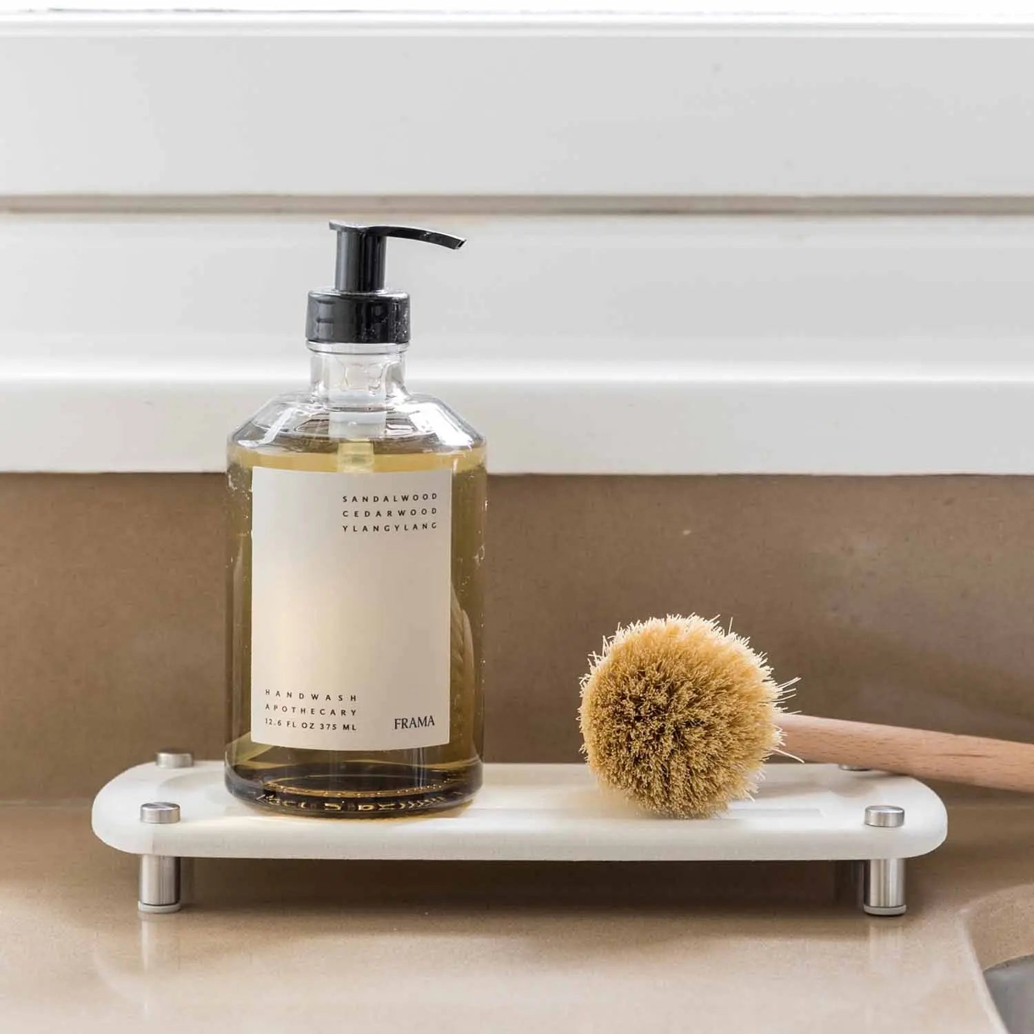 sandstone sink caddy with soap and brush