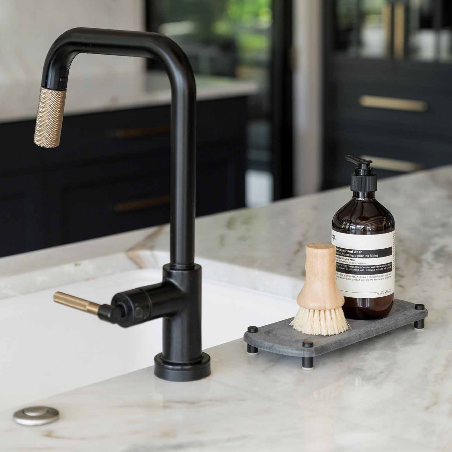 kitchen counter with sink organizer with soap and hand brush