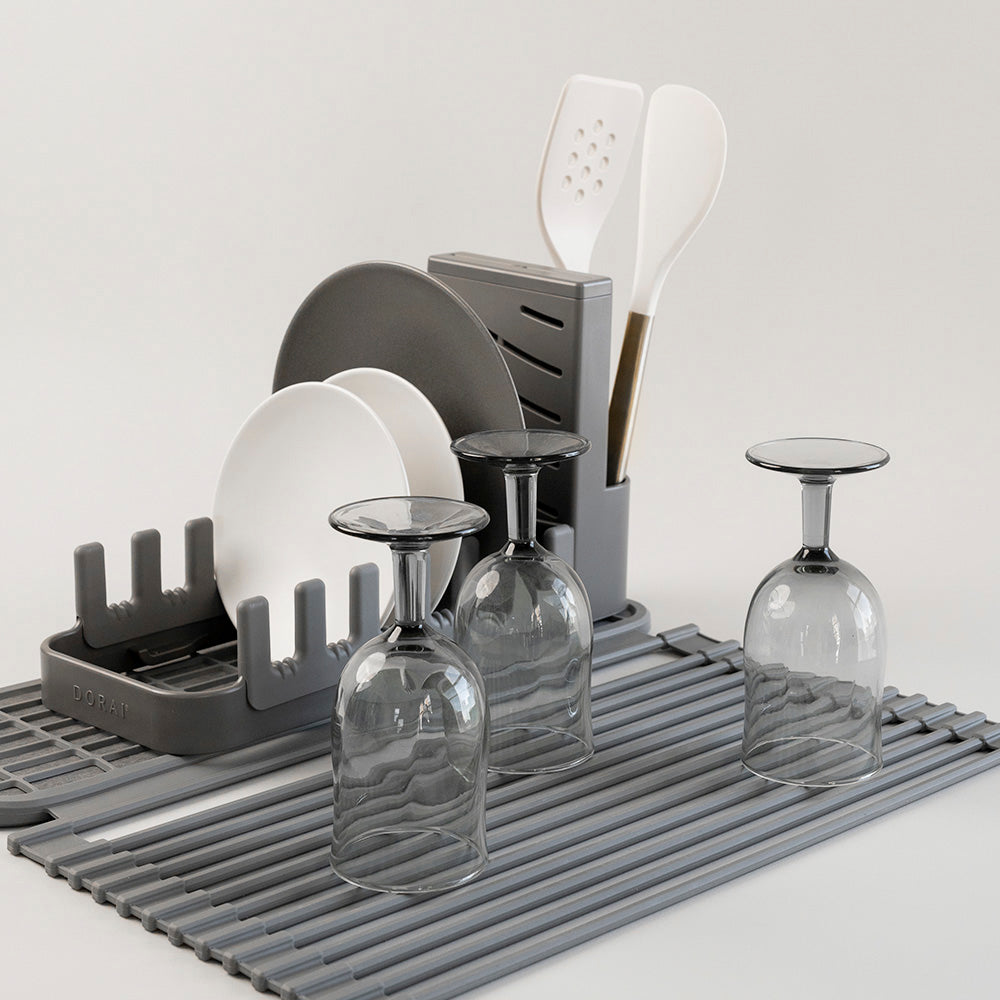 glasses being dried on over the sink part of the dish pad and loaded dish pad rack