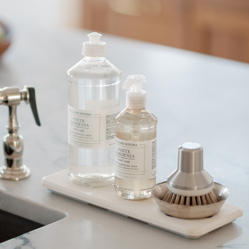 stone sink caddy in sandstone with 2 soap bottles and brush dish