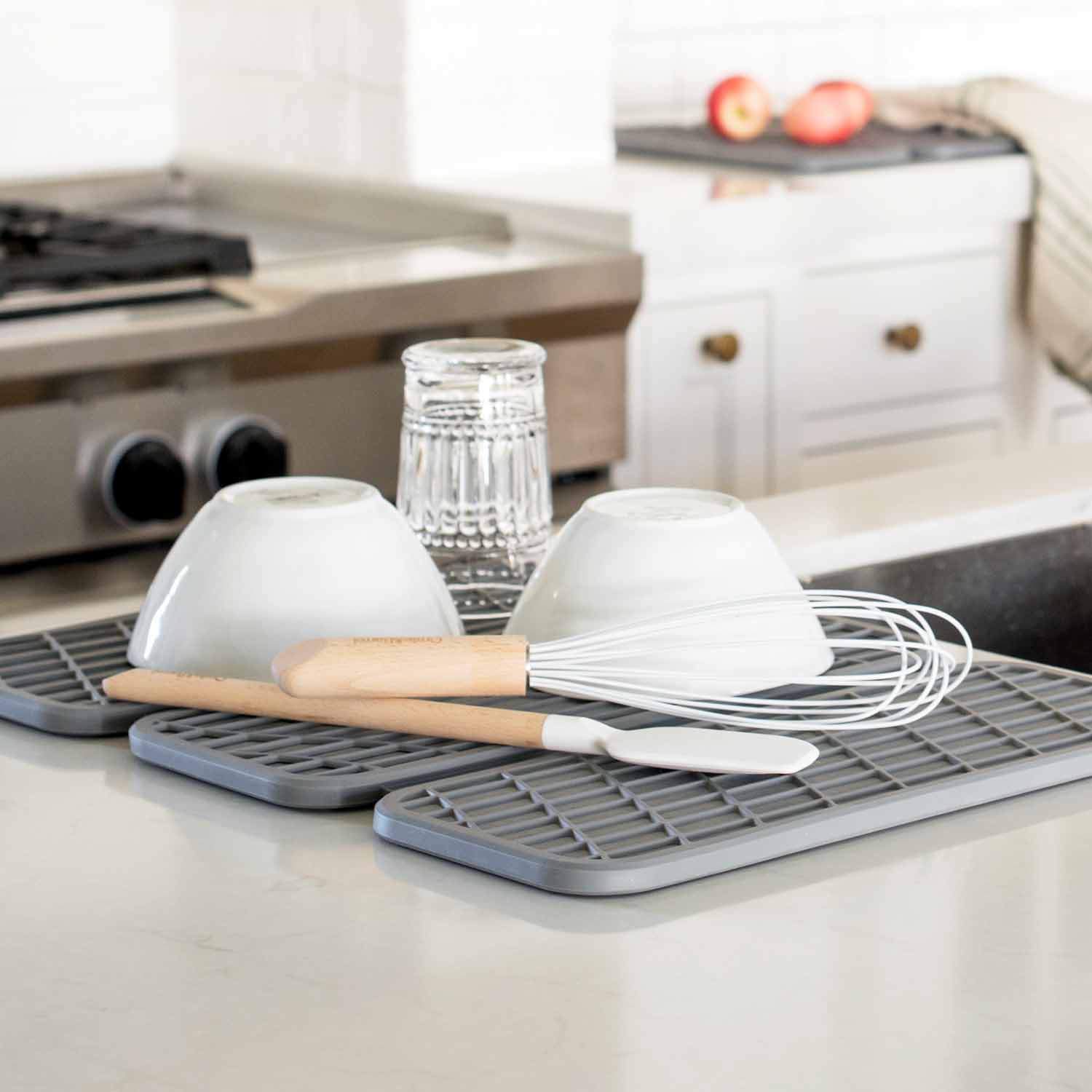 dark grey dish drying pad with utensils and dishes