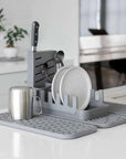 slate dish pad rack on slate dish pad with dishes and utensils on kitchen counter