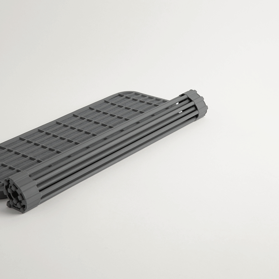 dark grey dish pad drainer being rolled up and out