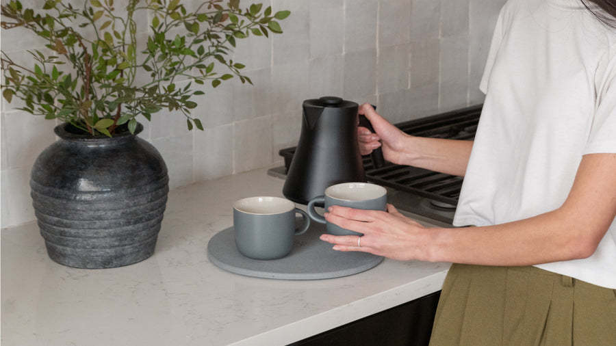 kettle and mugs on trivet