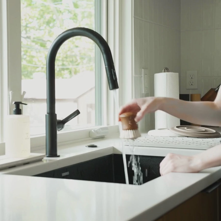 video of dish brush being put on stone sink caddy and quick drying of water drops