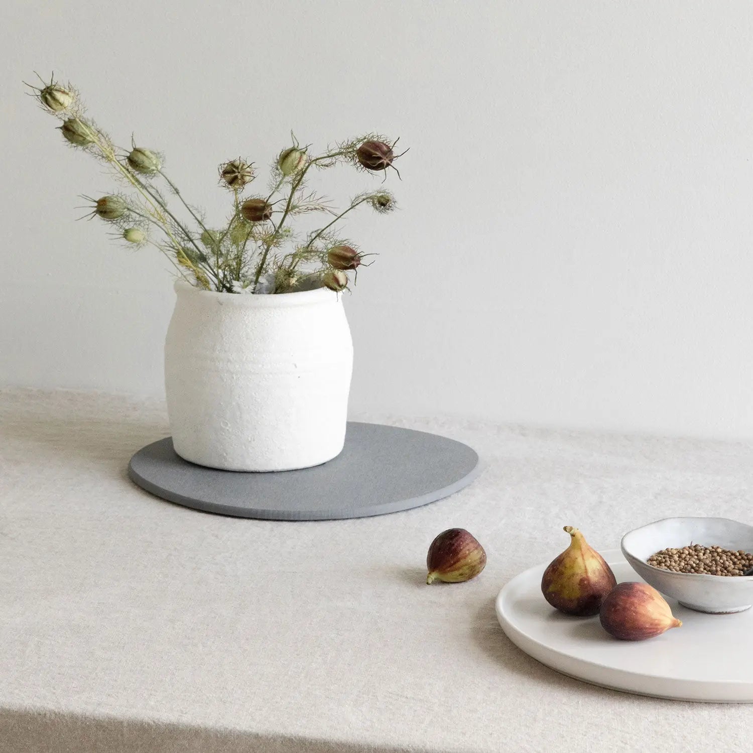 kitchen counter with vase on top of stone saucer in dark grey