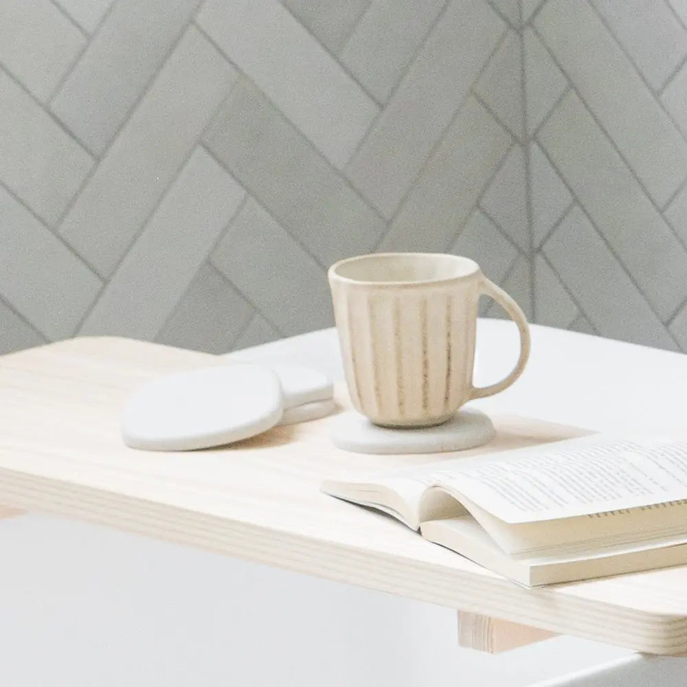 desk with coasters and hot drink
