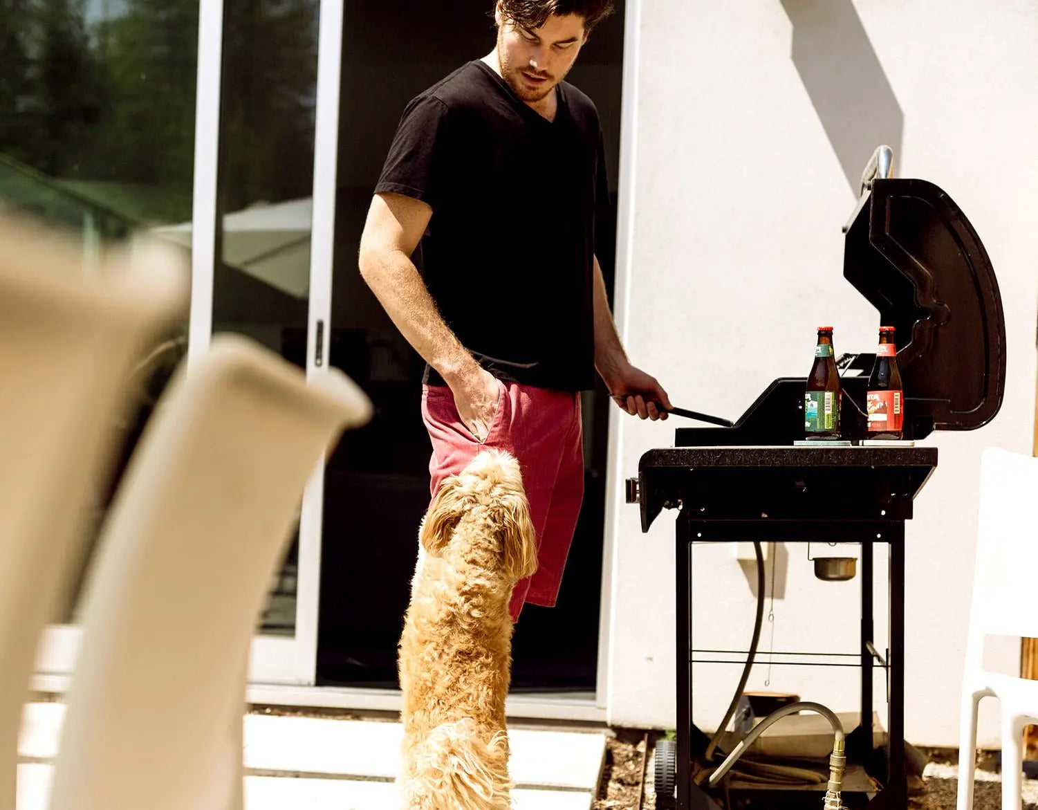 man with grill and dog on a sunny day