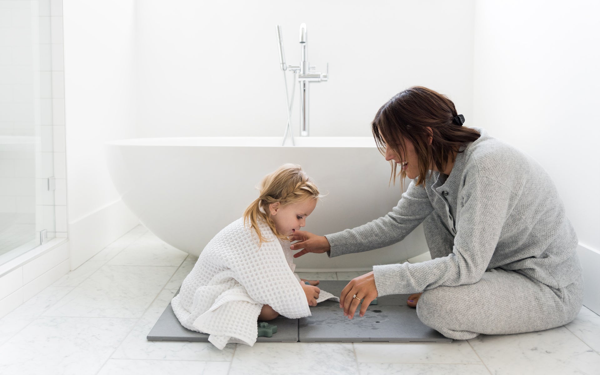 women with a toddler in bathroom