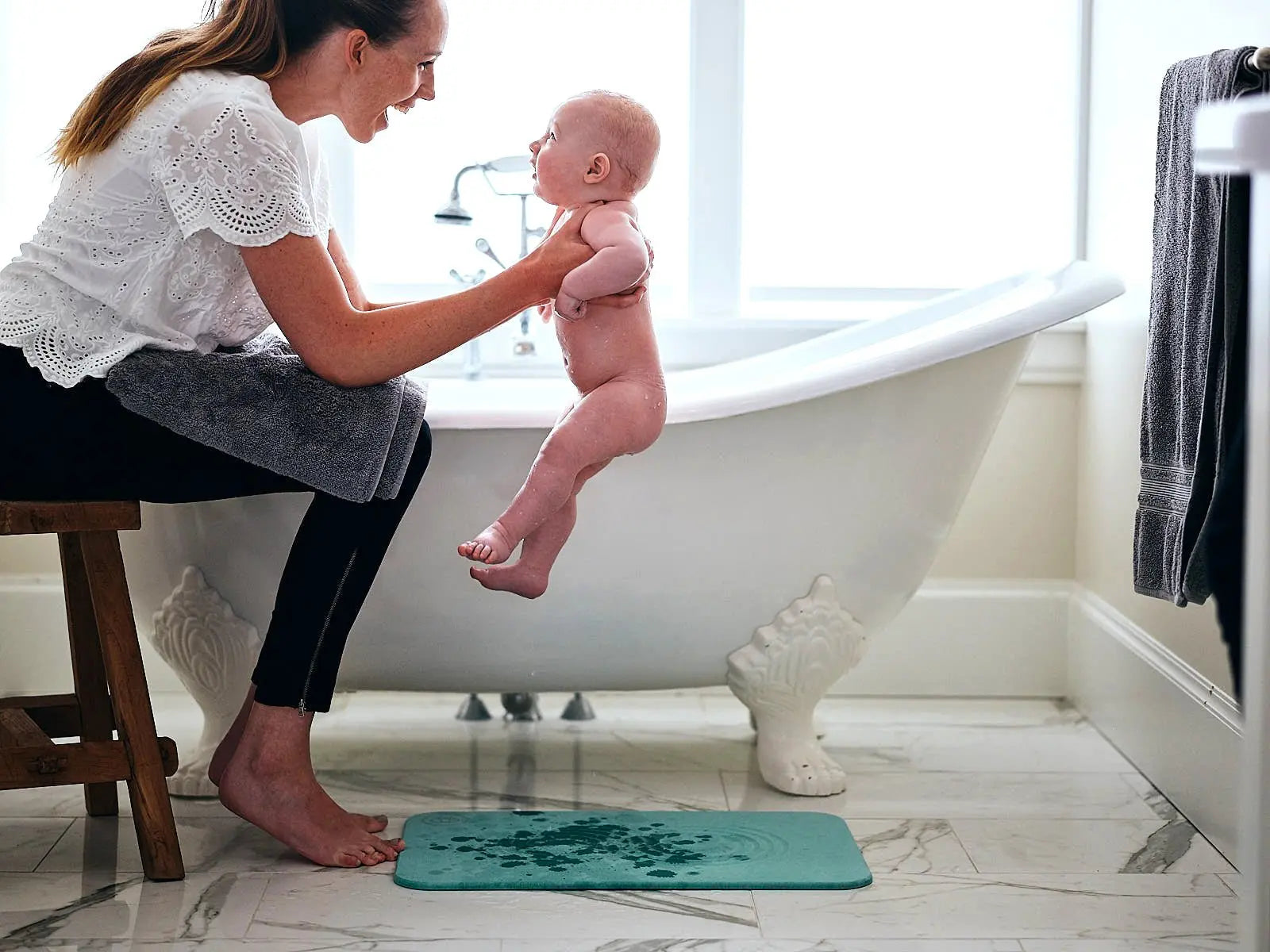 mother with a baby in a bathroom