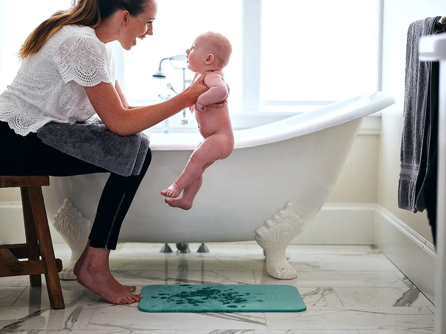 mother with a baby in a bathroom