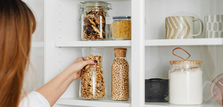 woman organizing kitchen cabinet