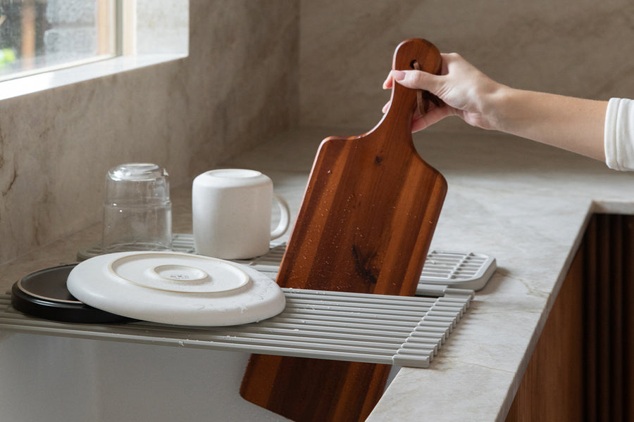 Dorai over-the-sink drying stone in Sandstone color, bridging a kitchen sink with a clean and practical look.