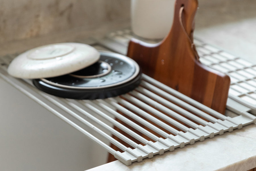 Dorai over-the-sink drying stone in Sandstone color, displayed on a kitchen sink, highlighting its functionality.