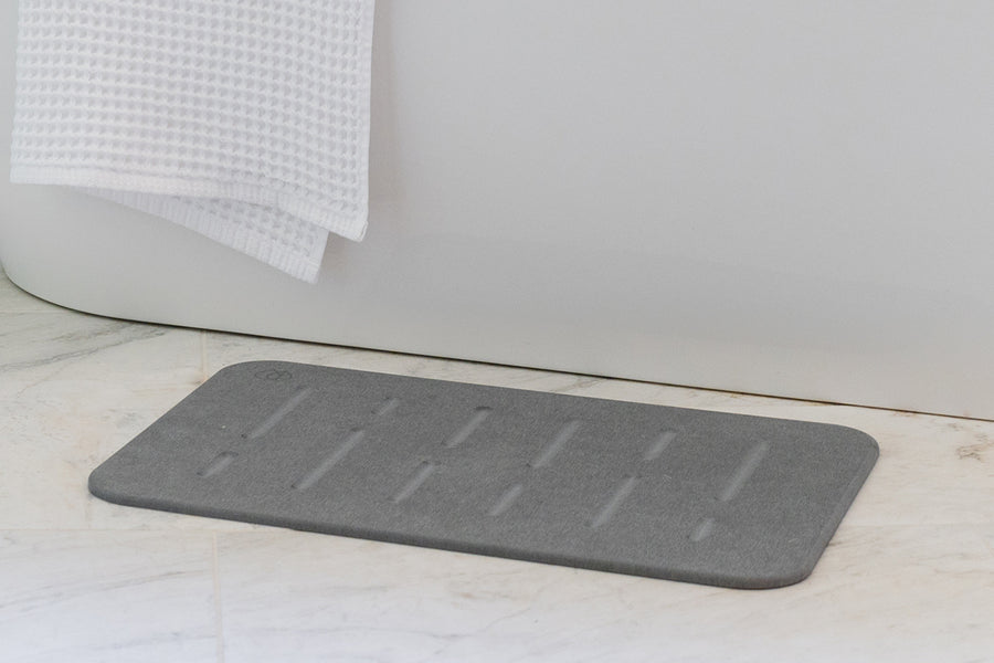 Dorai Bath Stone in Rain pattern with Slate color, displayed on a bathroom floor, emphasizing its modern look.