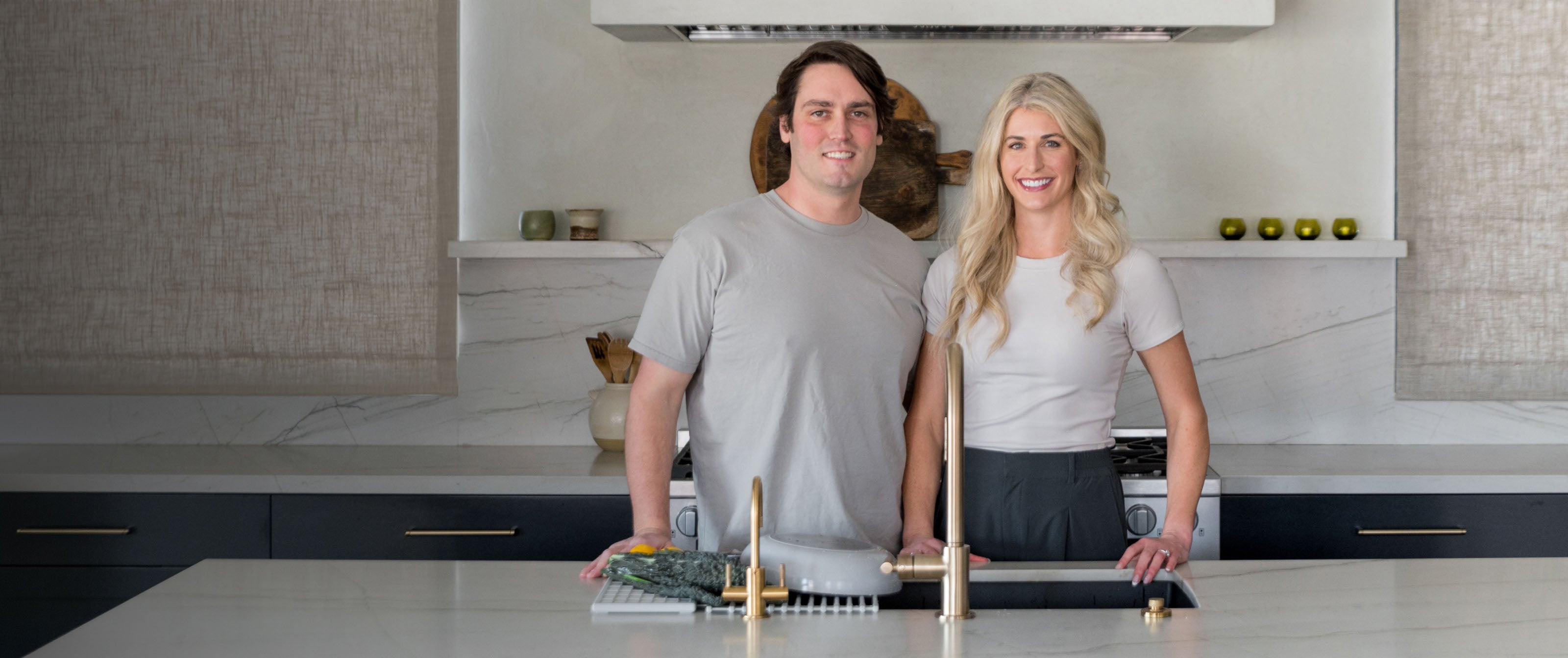 Founders Kelsey and Jason in a modern kitchen with Dorai products. 