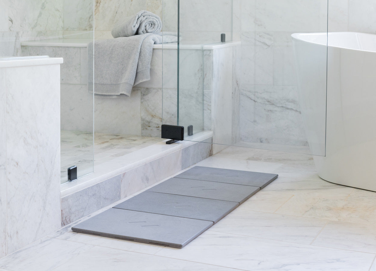 bathroom with grey bath stone mat