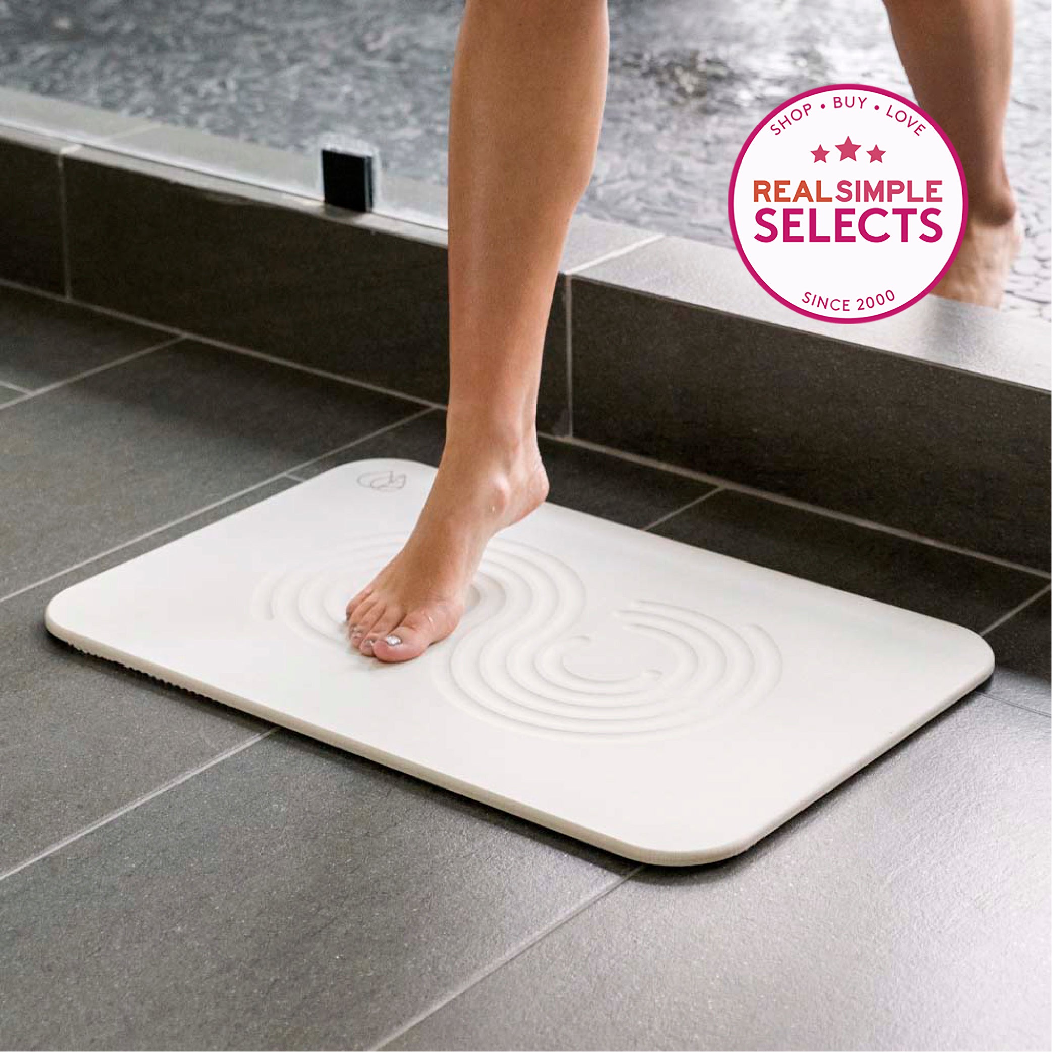 woman stepping on the bath stone mat