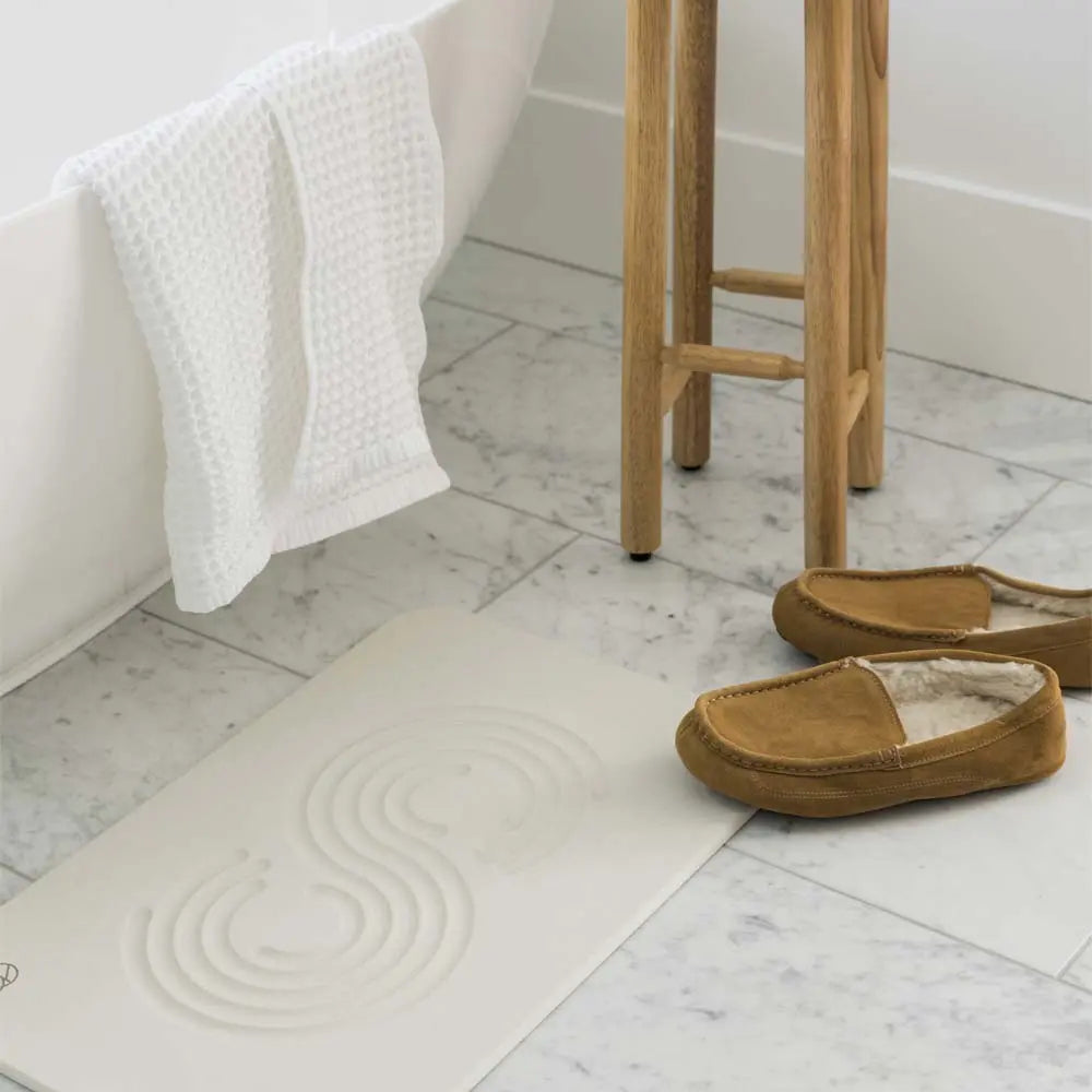 sandstone zen bath stone mat with shoes and bath tub