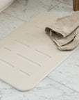 Sandstone Bath Stone Mat Rain with towel on it