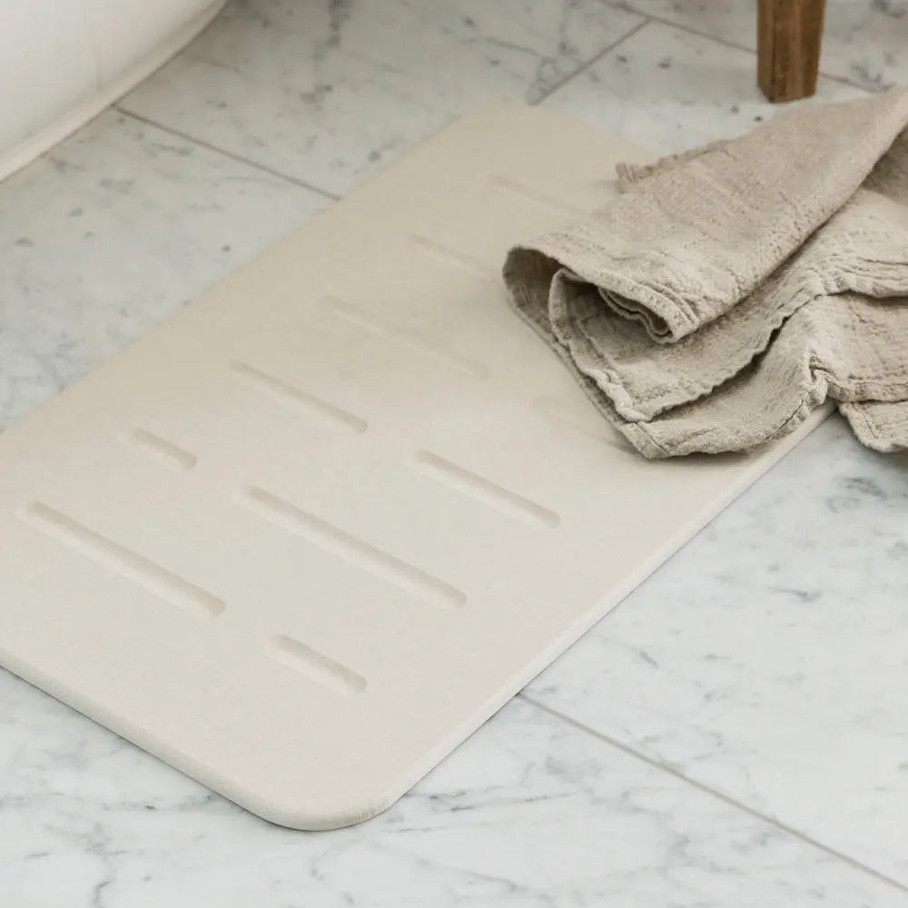 Sandstone Bath Stone Mat Rain with towel on it