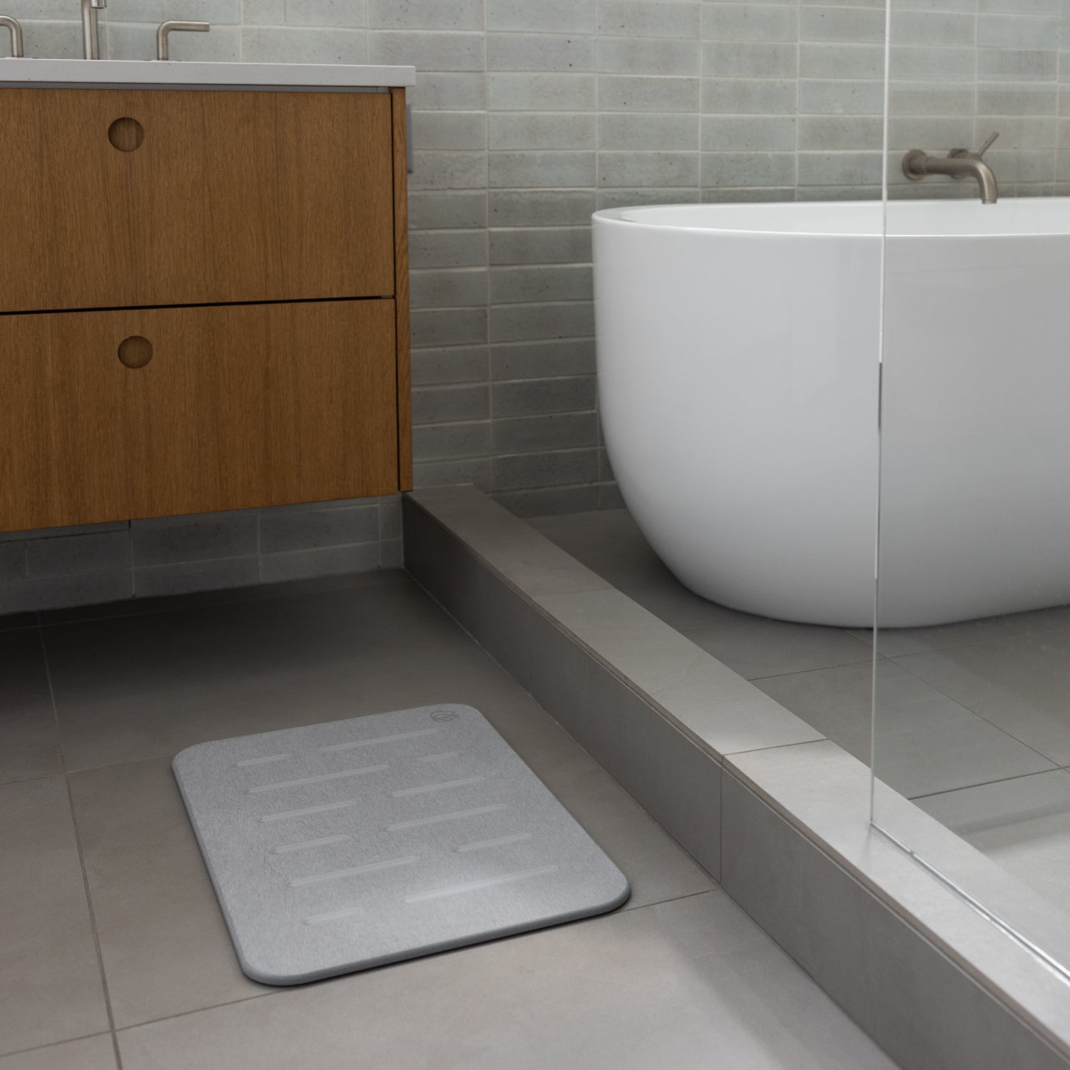 light grey shower bath mat on bathroom floor