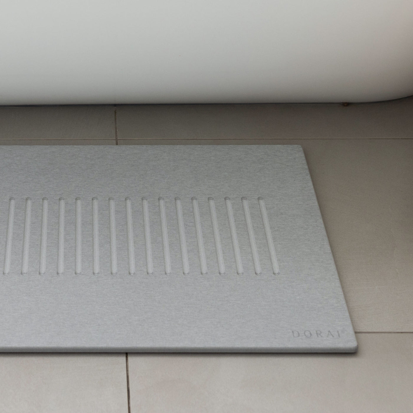 Original bath stone in Ash in front of free-standing tub