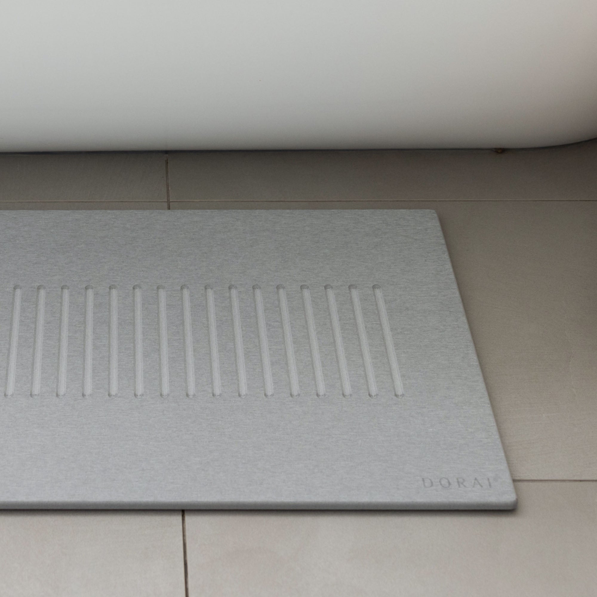 Original bath stone in Ash in front of free-standing tub