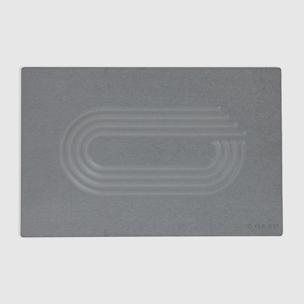 Gray modern quick drying bath mat with embossed design on a light gray background