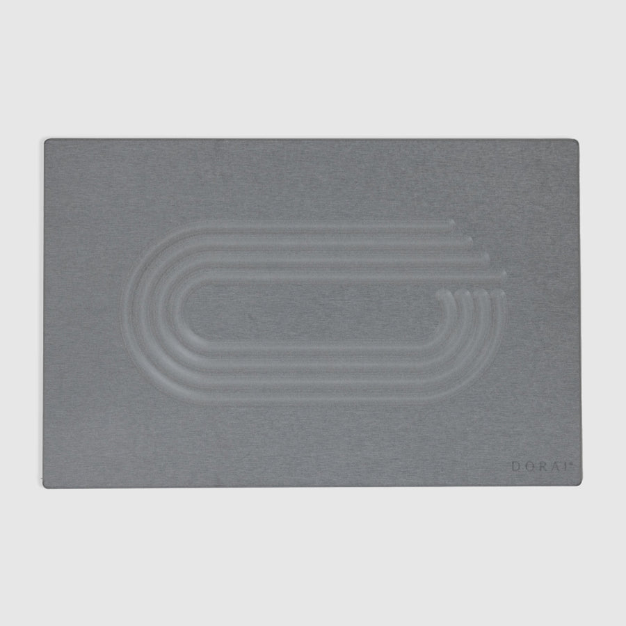 Gray modern quick drying bath mat with embossed design on a light gray background