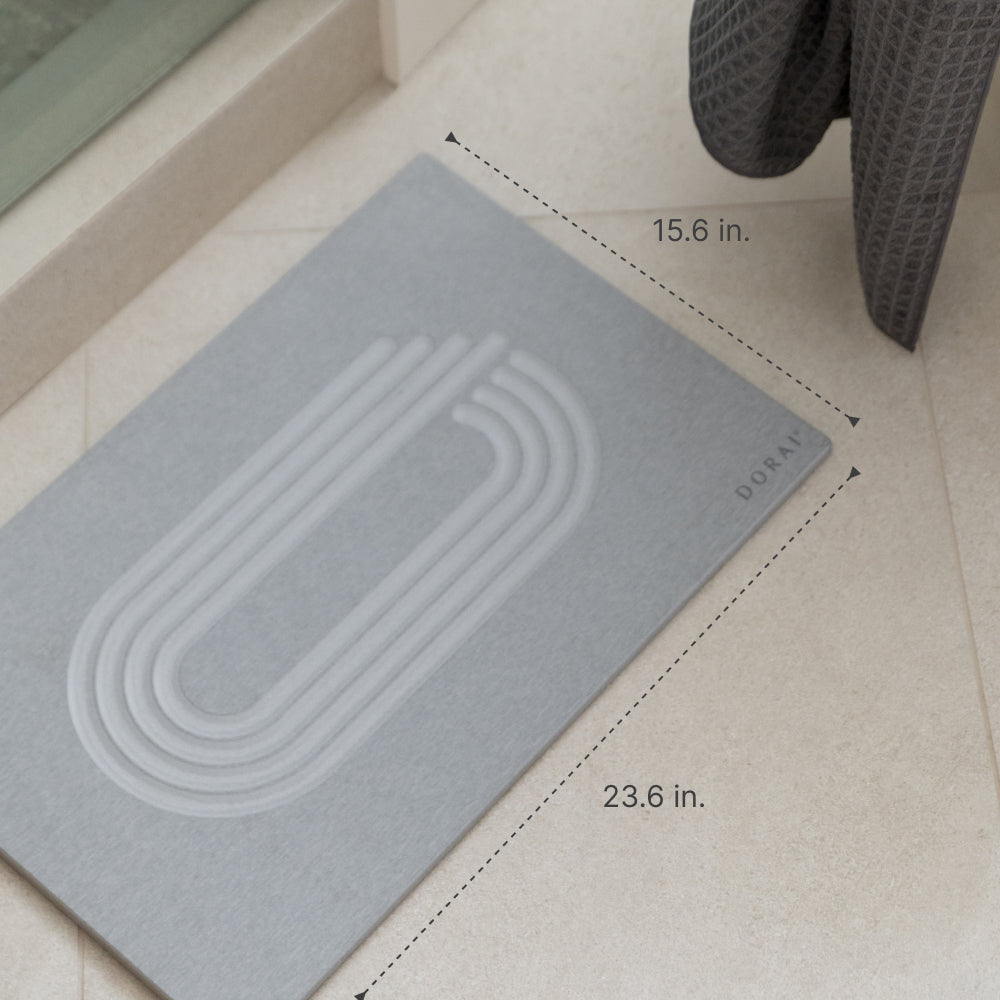 Gray mat with measurements on a light tlle floor