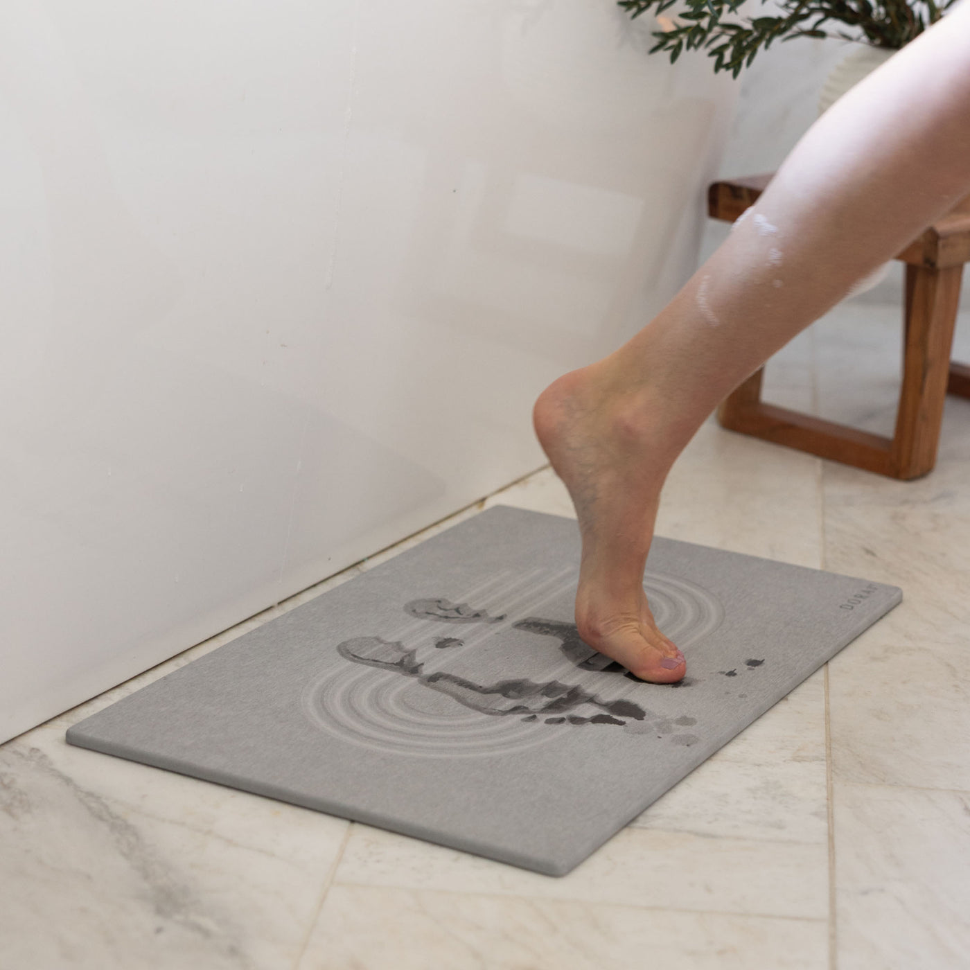 Original Current bath stone in Ash quickly absorbs water from wet feet in bathroom. 