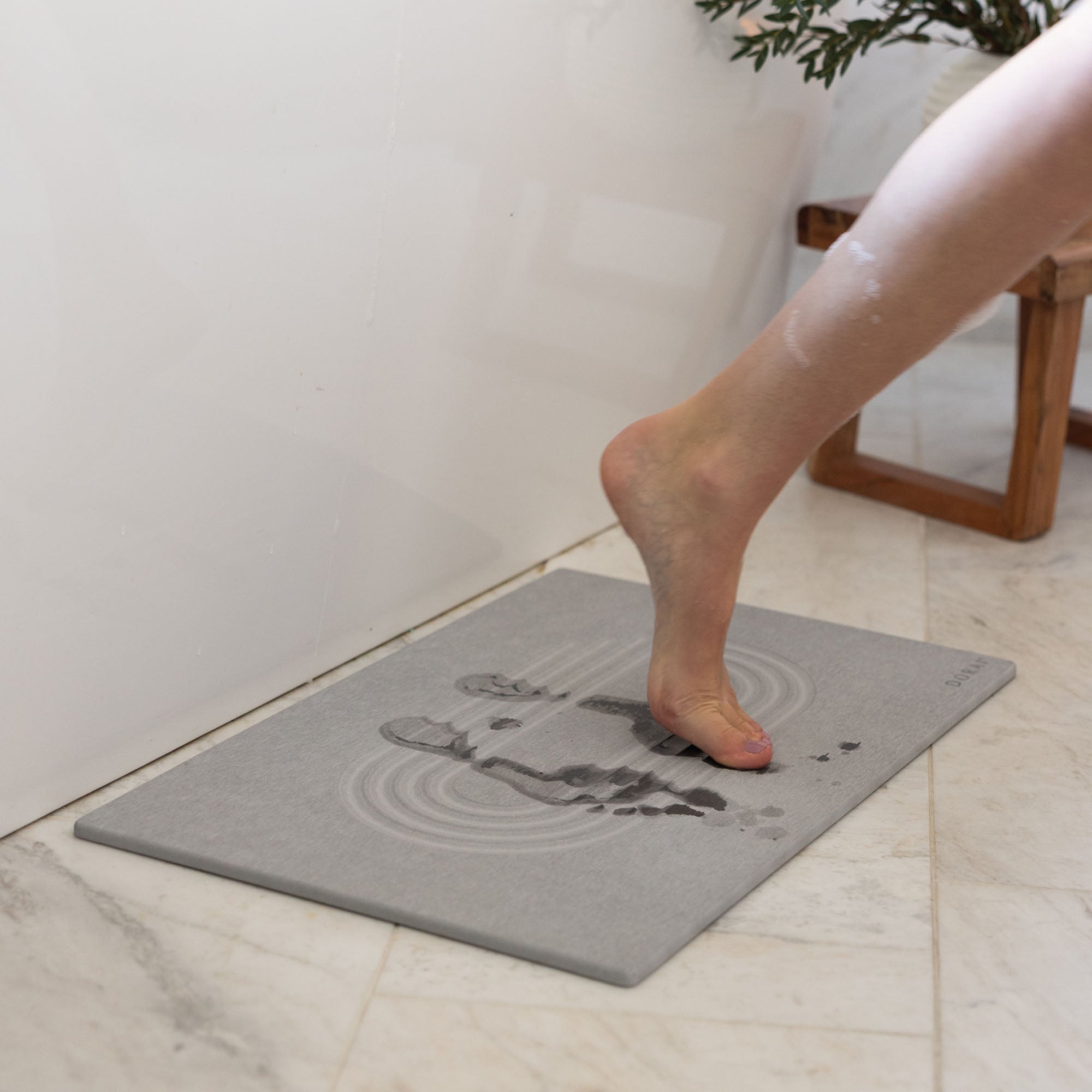 Original Current bath stone in Ash quickly absorbs water from wet feet in bathroom. 