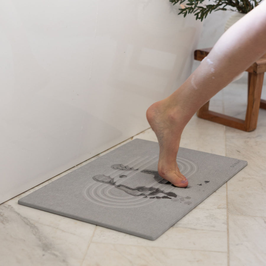 Original Current bath stone in Ash quickly absorbs water from wet feet in bathroom. 