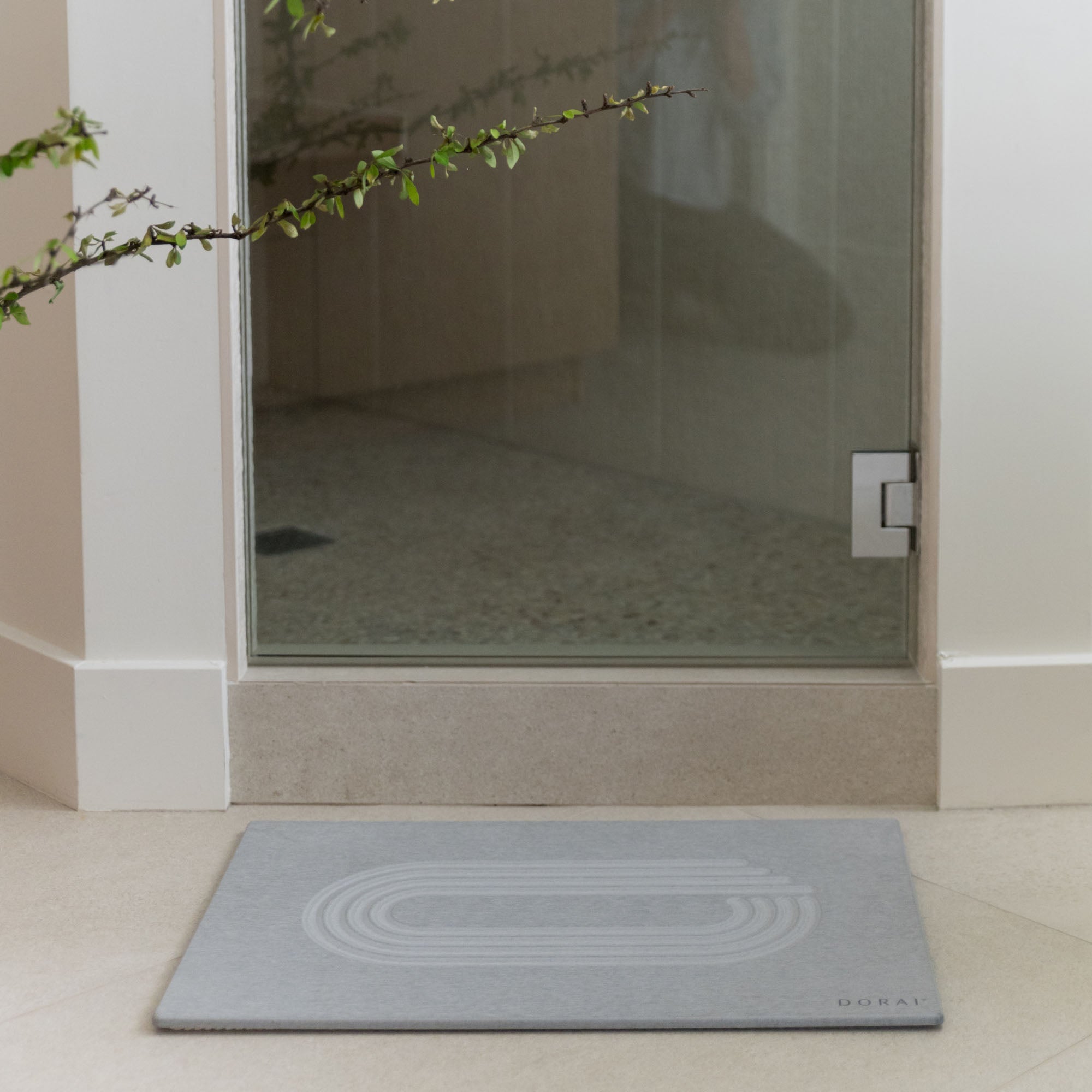 Original Bath Stone in Ash in front of shower door in minimal bathroom