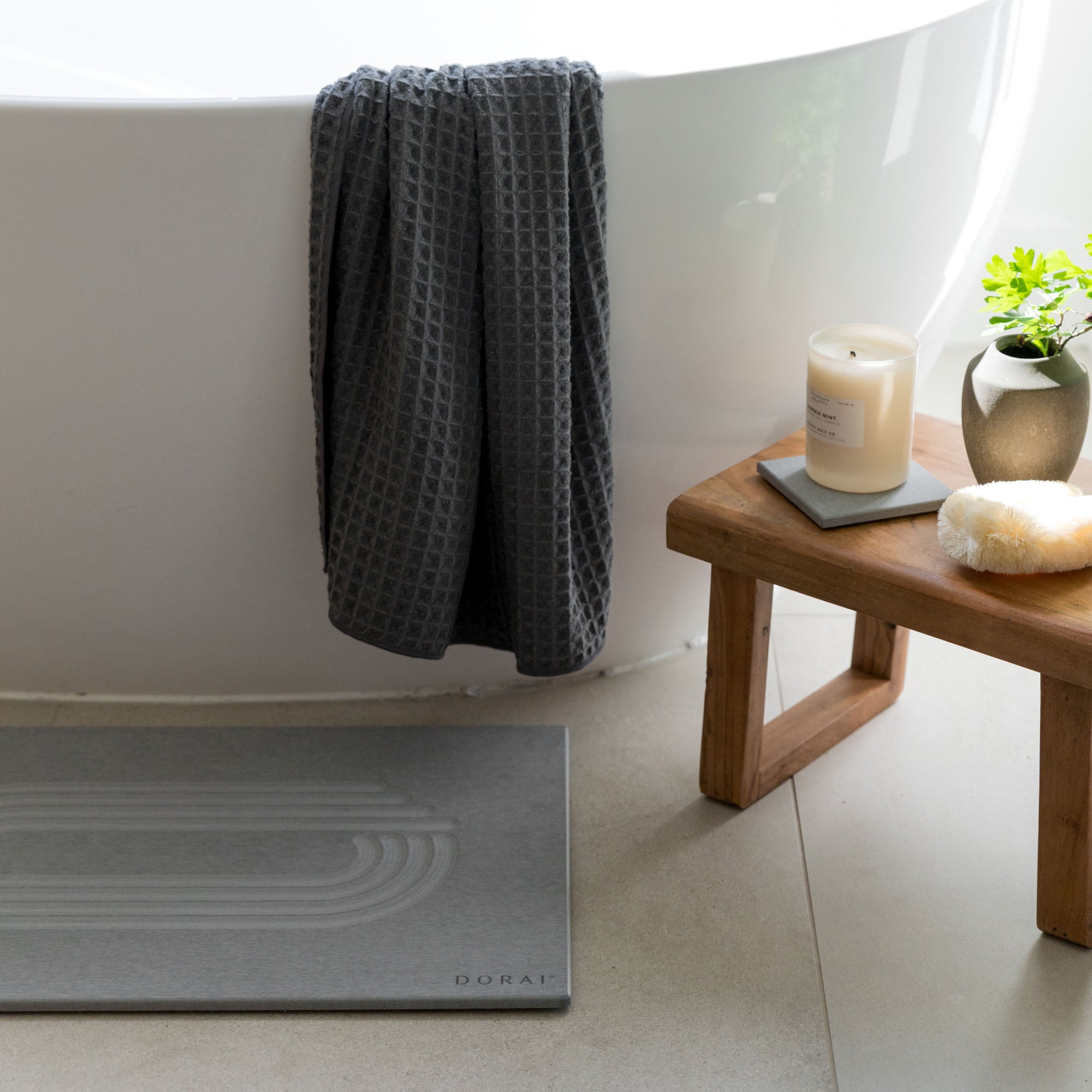 Original bath stone in Ash for quick-drying in front of free-standing 