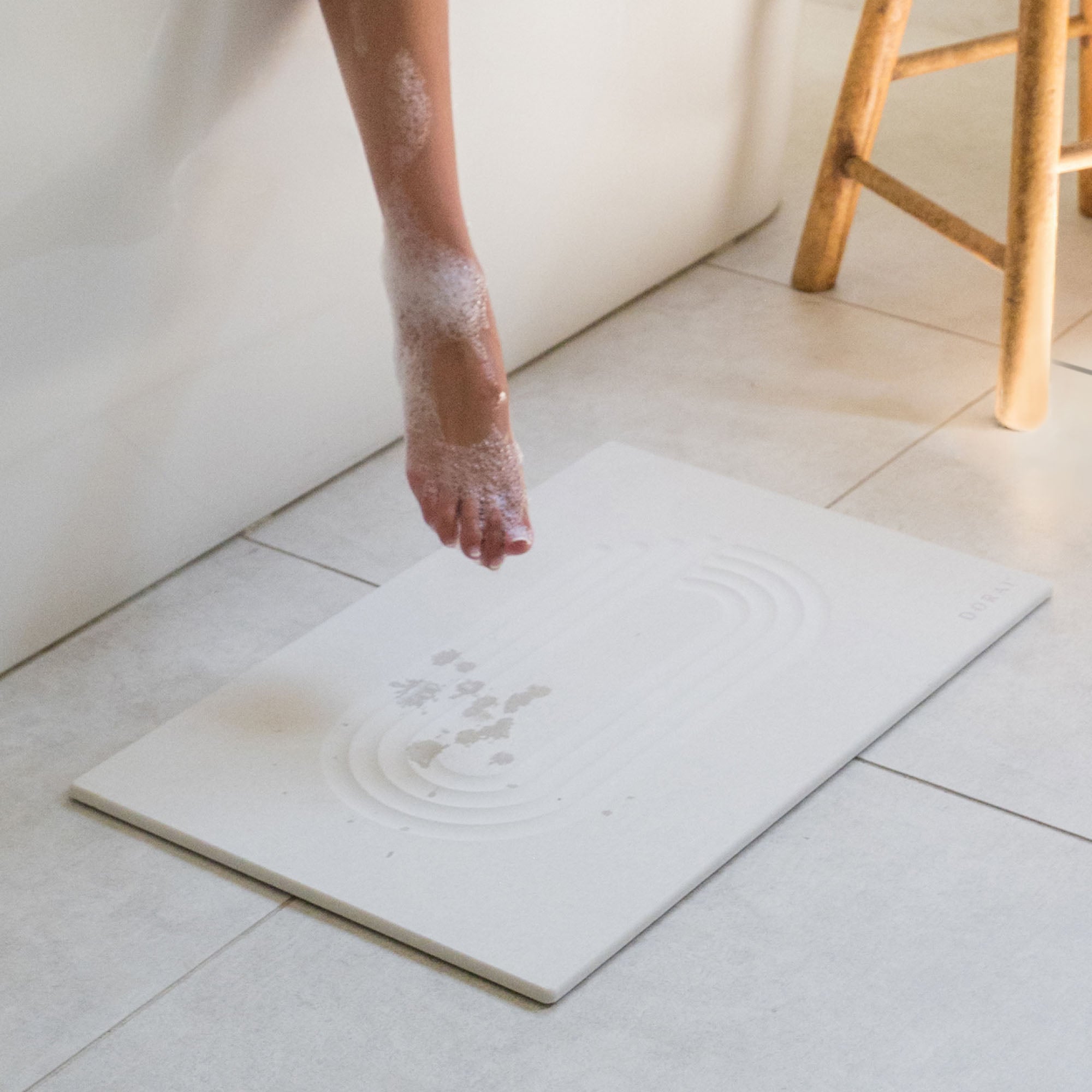 Original Current bath stone in Sandstone quickly absorbs water from wet feet in bathroom. 
