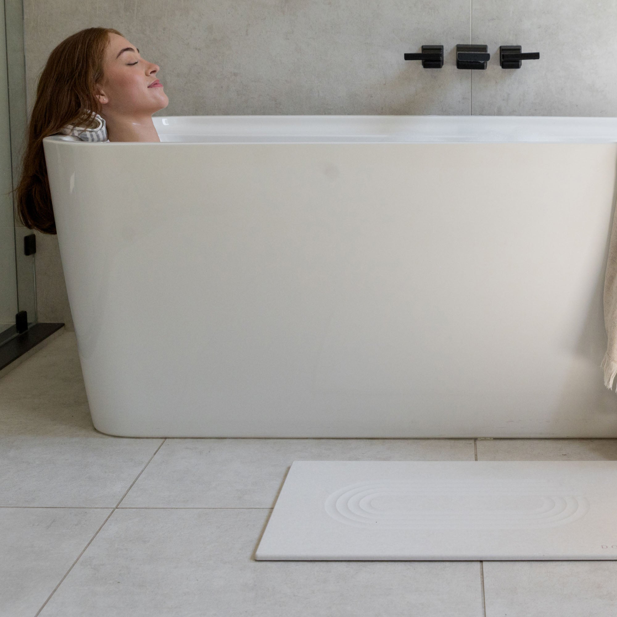 Original bath stone in Sandstone in front of free-standing tub in modern bathroom