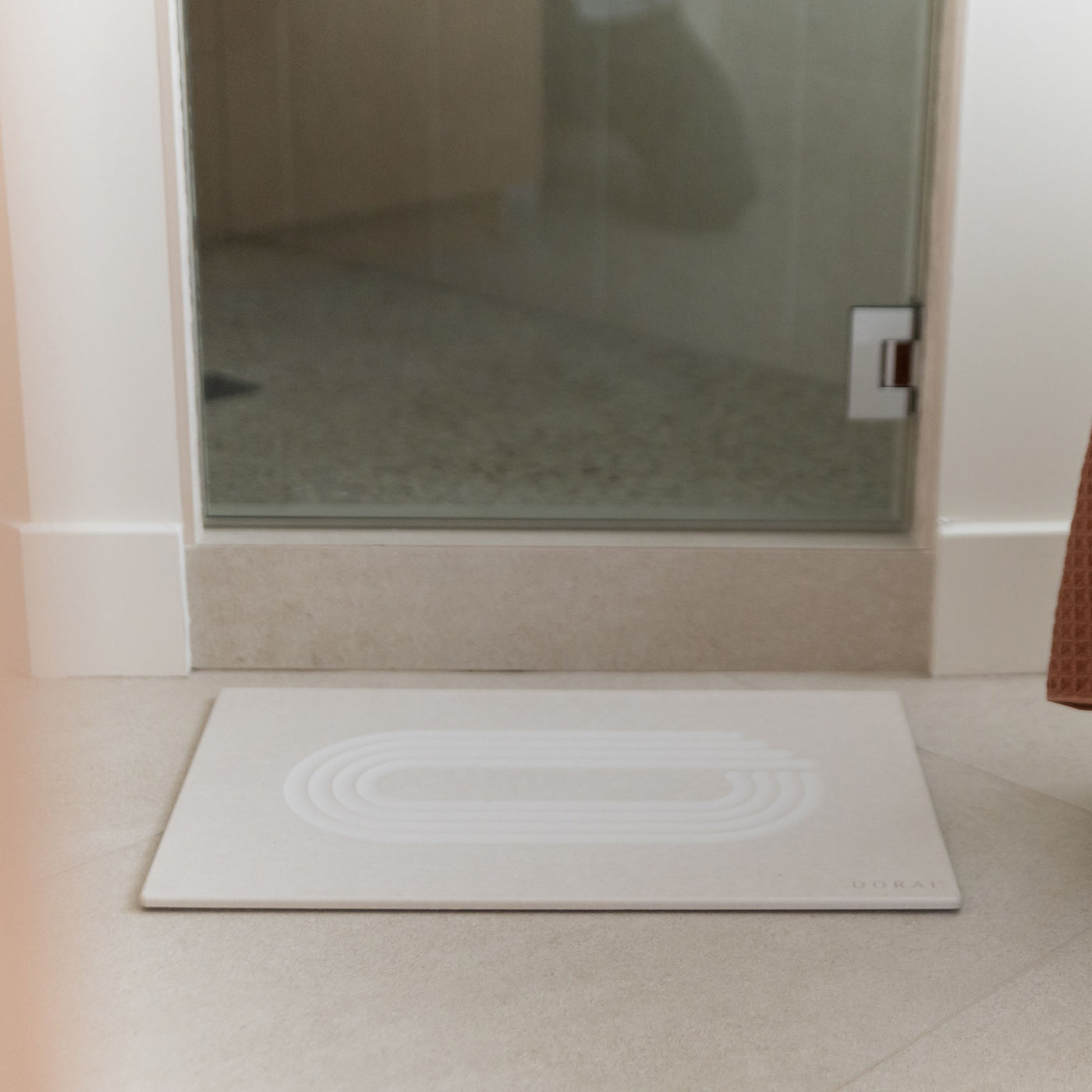 Original Bath Stone in Sandstone in front of shower door in minimal bathroom
