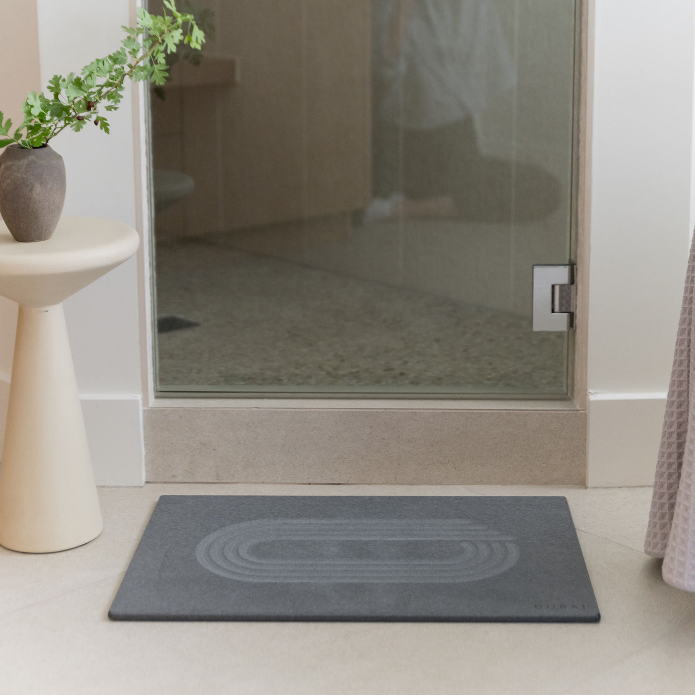 Original Bath Stone in Slate in front of shower door in minimal bathroom
