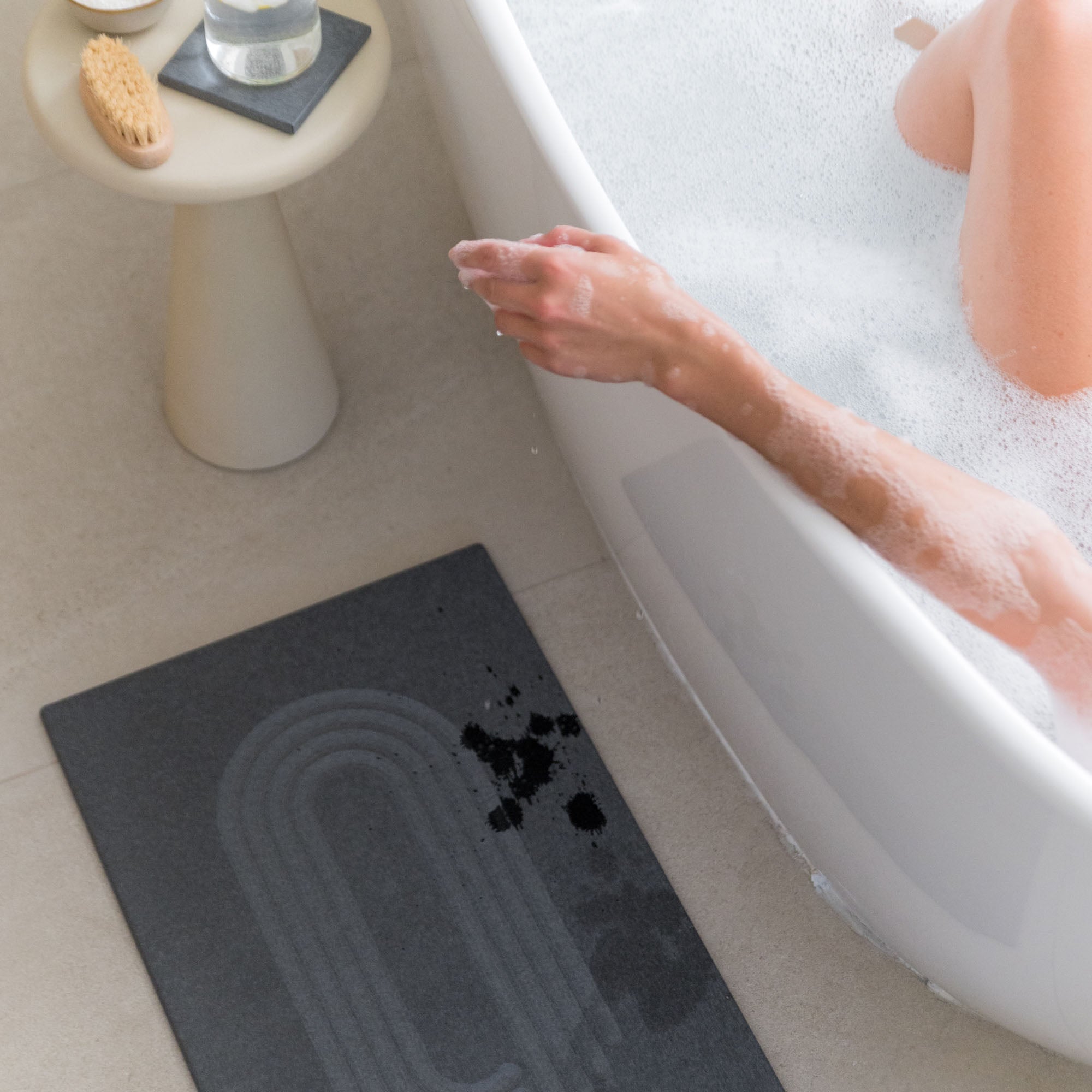 Original Current bath stone in Slate quickly absorbs water drops next to bath tub