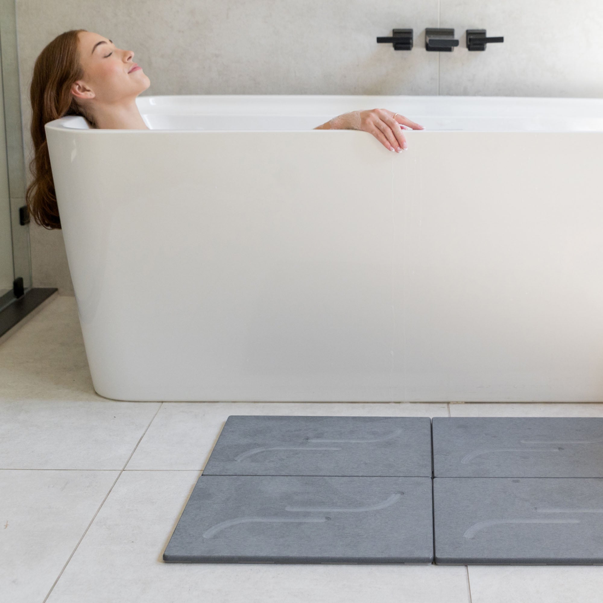Large arch bath stone mate in slate for quick-drying outside large free-standing tub.