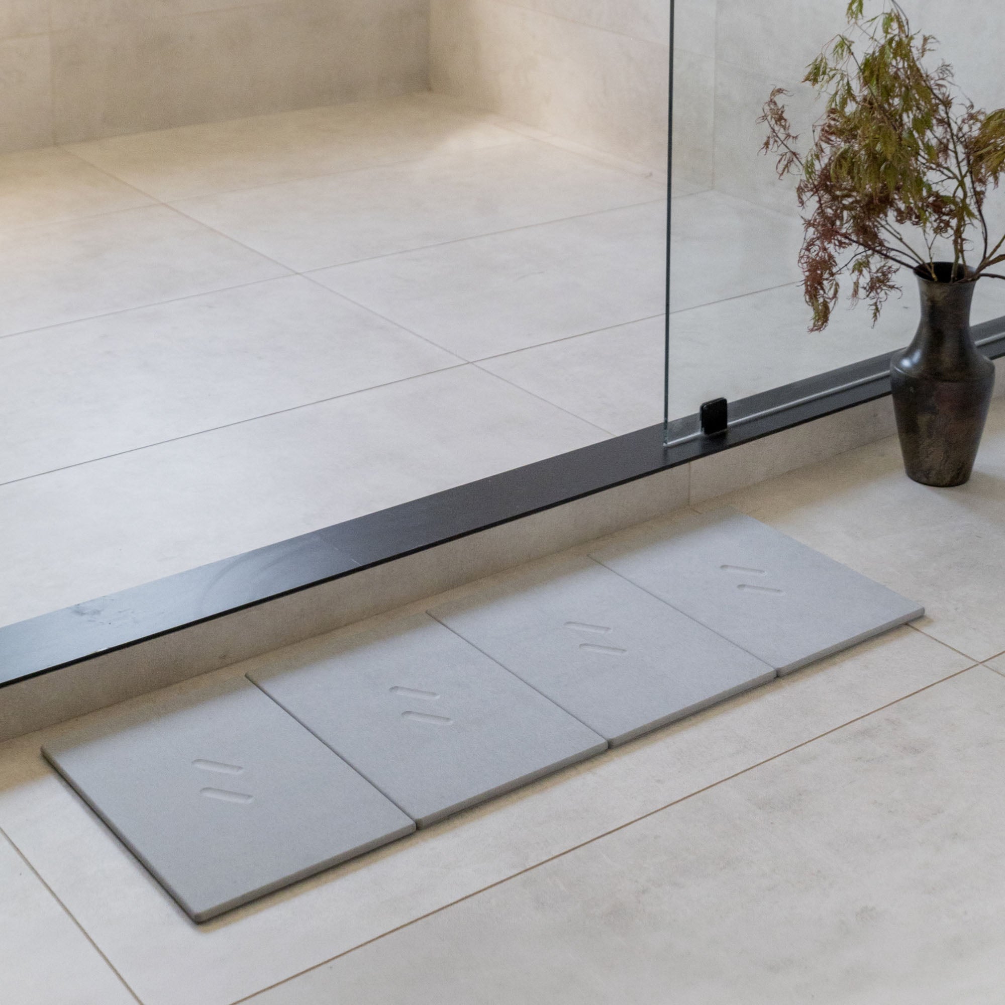 Large Alta Bath Stone in Ash stretched layout in modern bathroom.