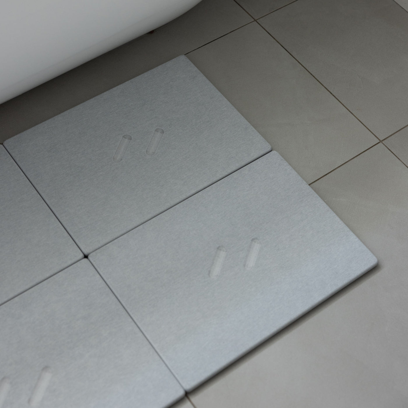 Large Alta bath stone mate in Ash for quick-drying outside large free-standing tub.