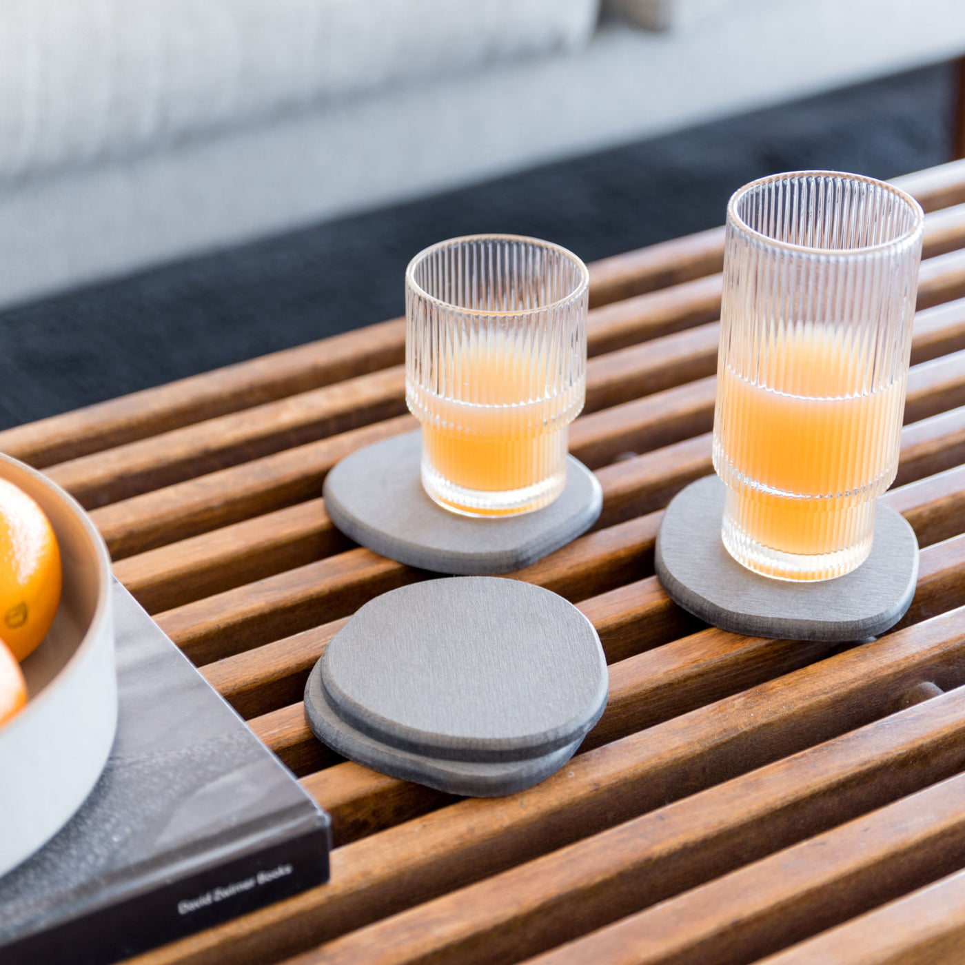 Slate Stone Coaster on wooden table with drinks.
