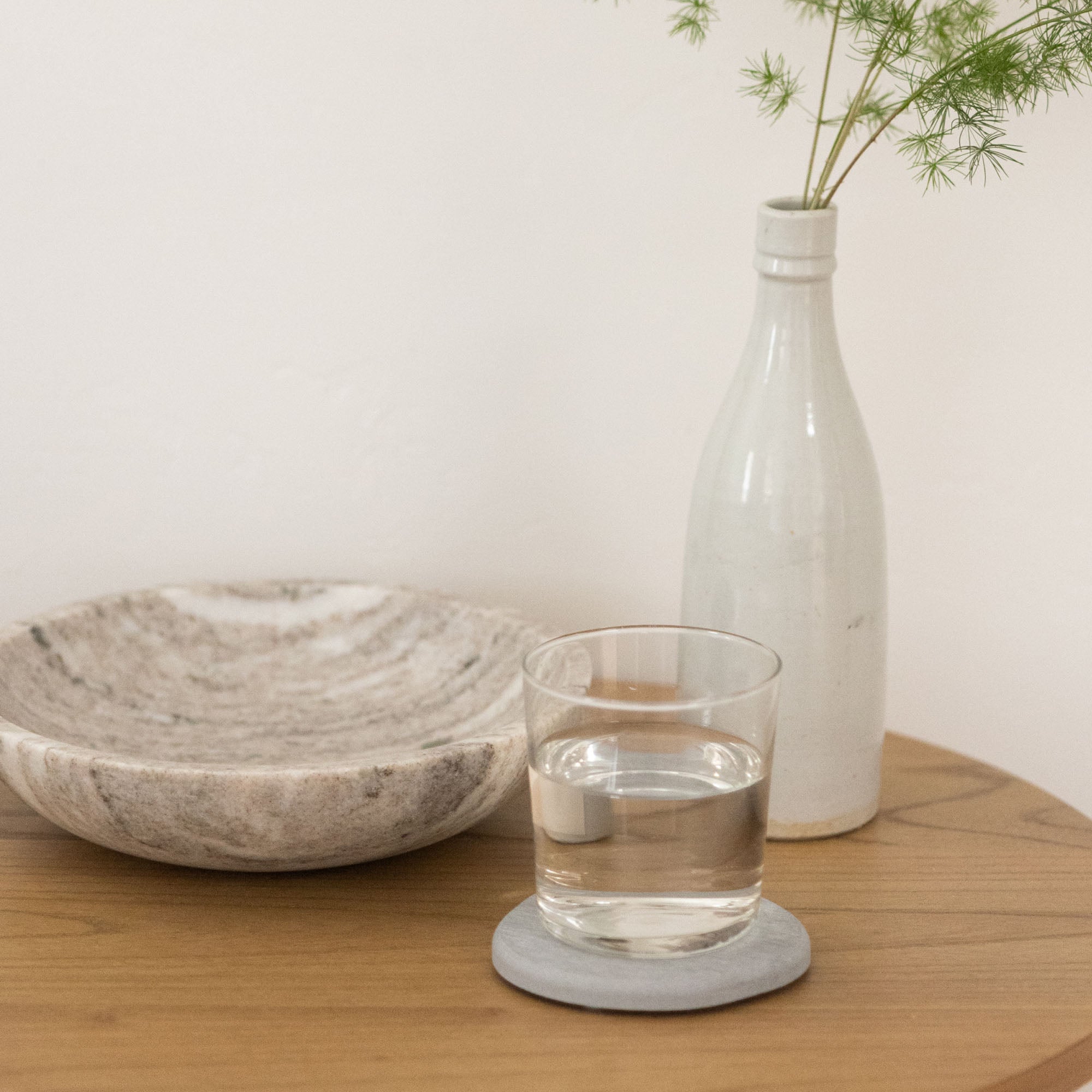 Ash Stone Coaster on small table with drink.