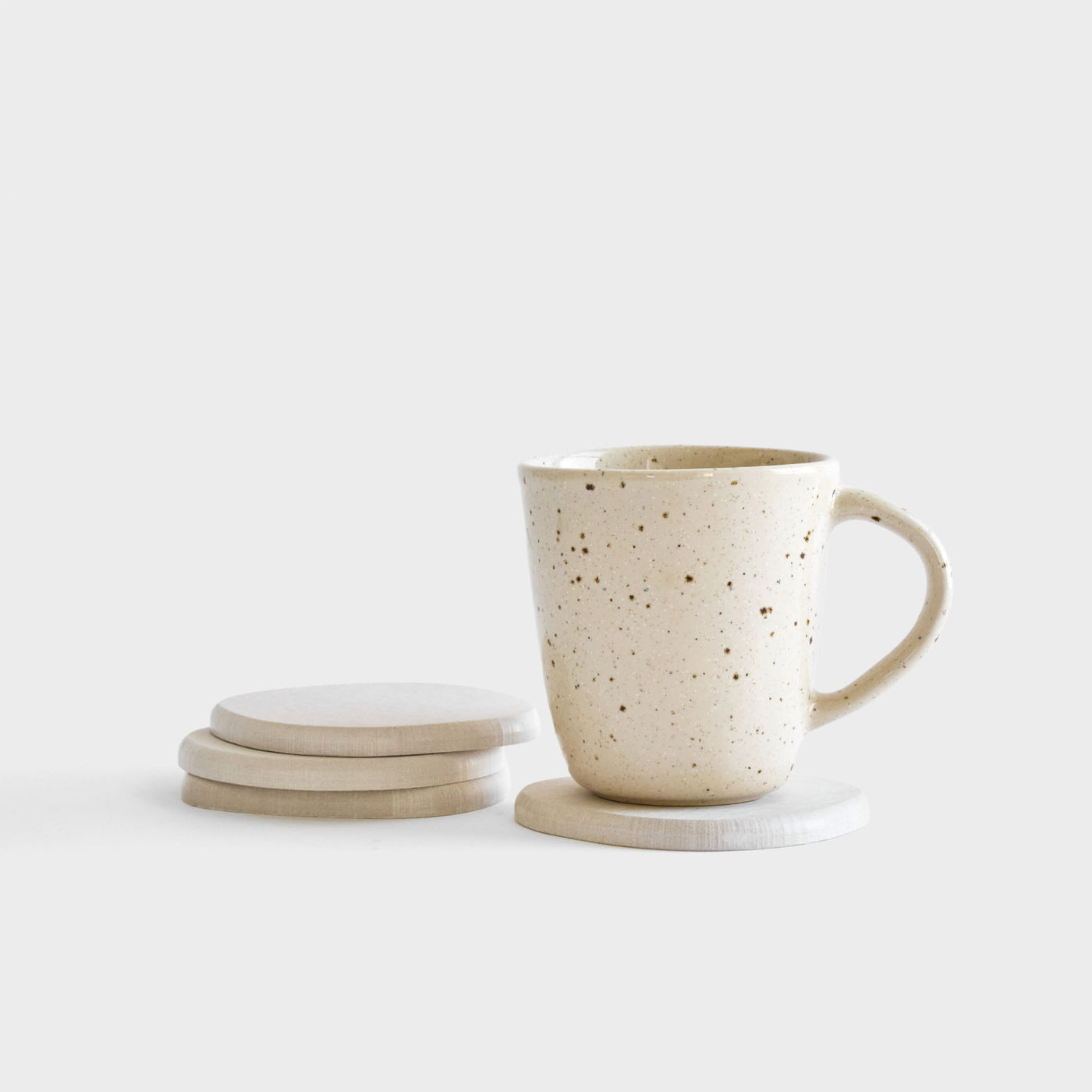 Sandstone Stone Coaster set stacked with drink.