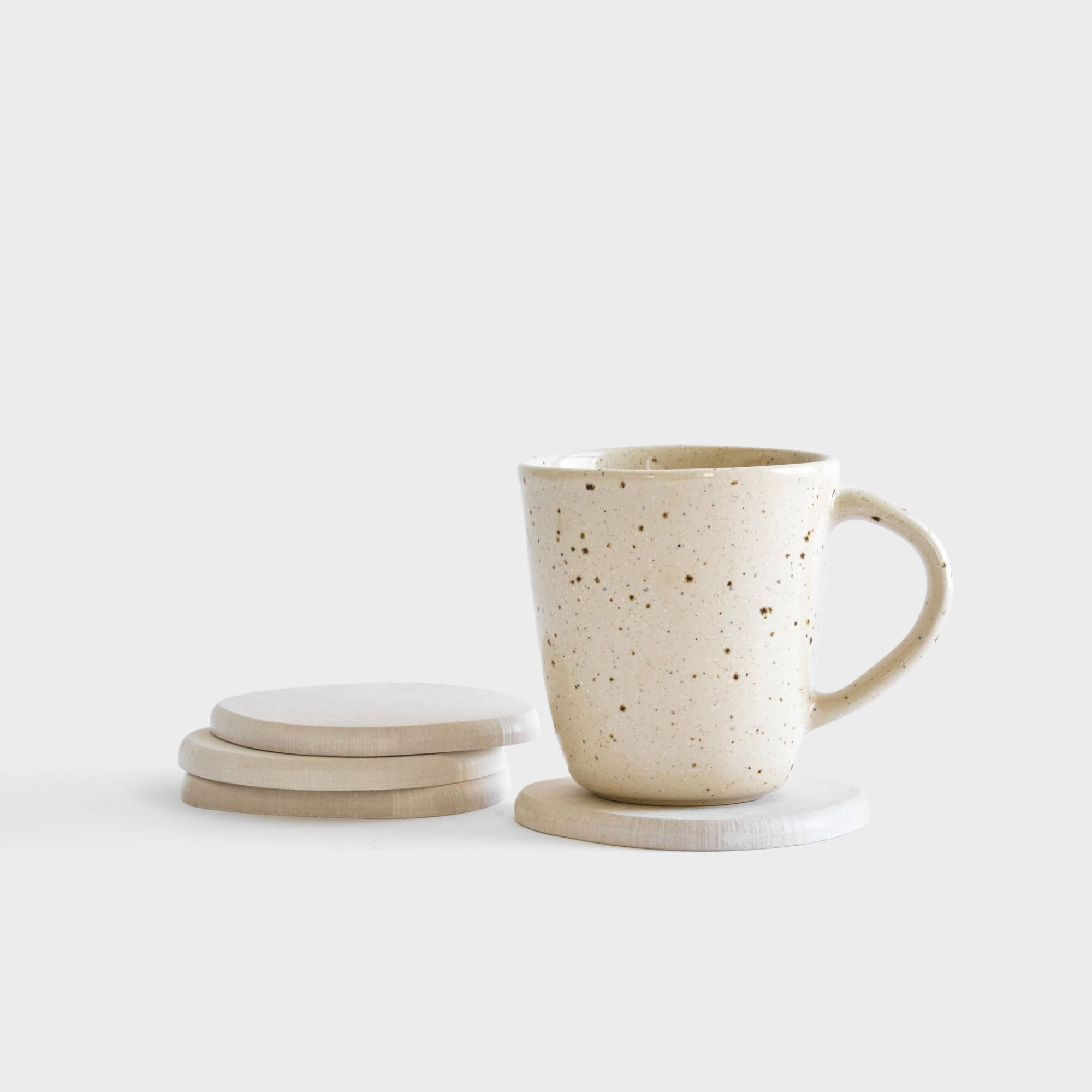 Sandstone Stone Coaster set stacked with drink.